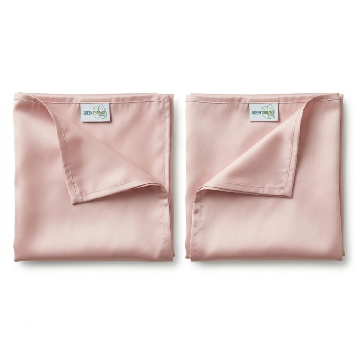 Pair of blush pink bamboo lyocell pillowcases for cooler sleep and gentle care for hair and skin.