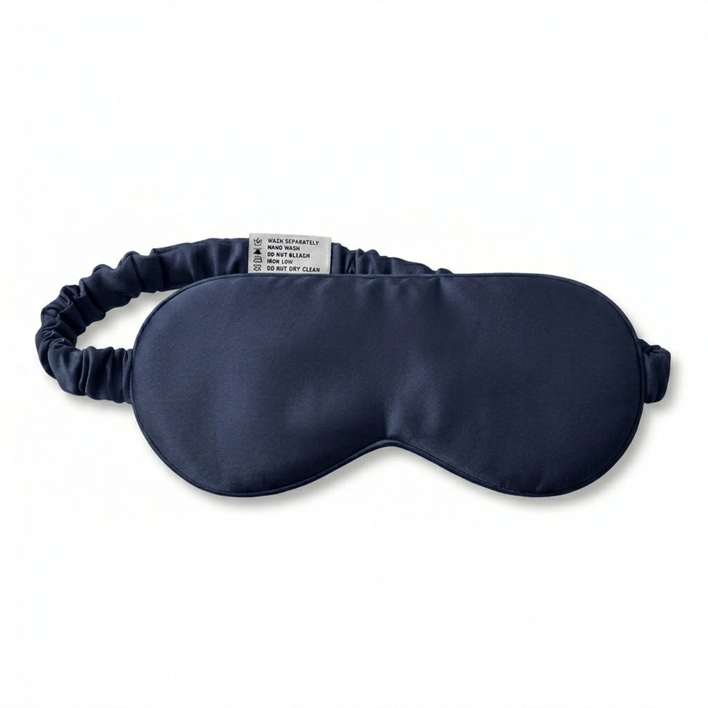 Navy bamboo lyocell sleep eye mask — care label and brand tag close-up.