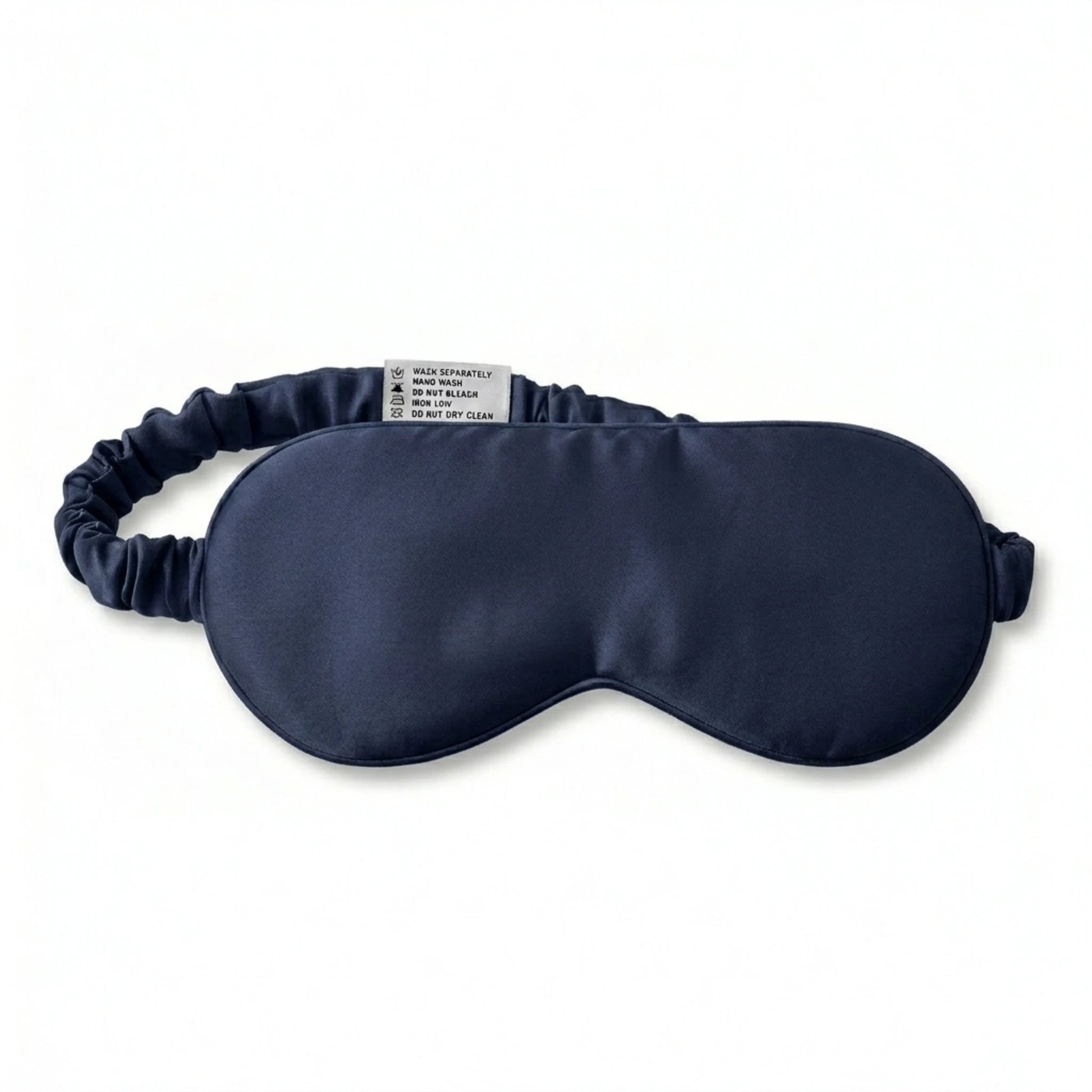 Navy bamboo lyocell sleep eye mask — care label and brand tag close-up.