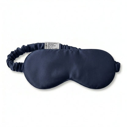 Navy bamboo lyocell sleep eye mask — care label and brand tag close-up.
