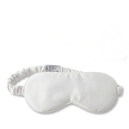 White bamboo lyocell sleep eye mask — front view showing contoured blackout design.